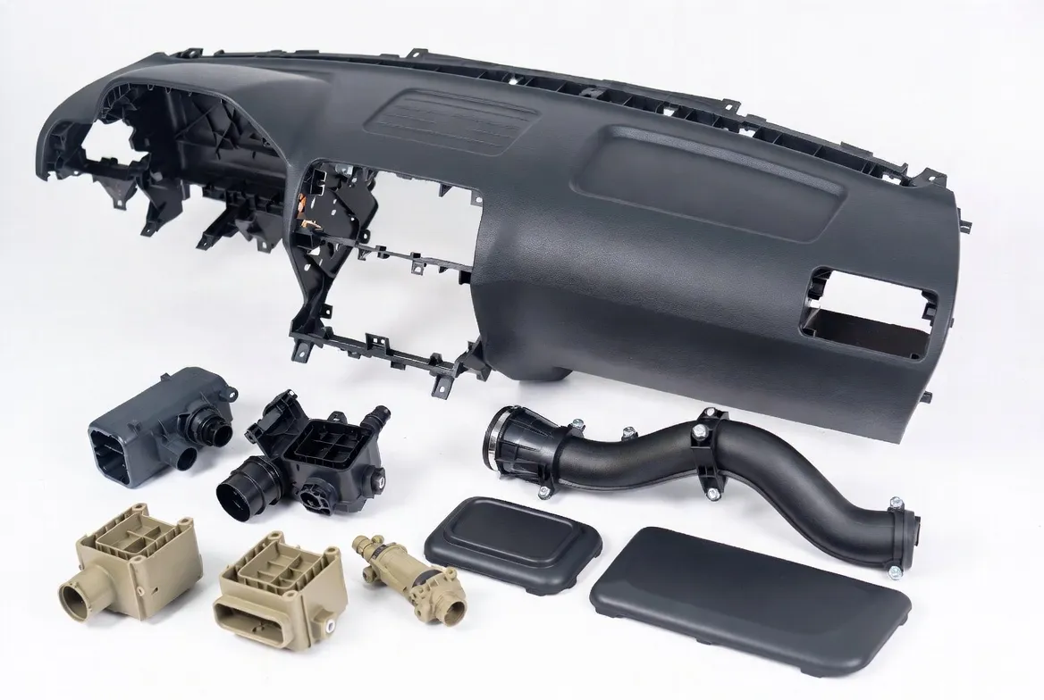 Injection molded, CNC machined and polymer 3D printed engineering plastics automotive parts: ABS, PC, PA6/PA66, PEEK, PPS including interior trim, dashboards, connectors, housings, air intake manifolds and sensor mounts in various colors on clean white background